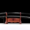 A training Iaido Katana with a black blade, displayed next to its scabbard on a small wooden stand.