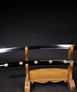 A black Japanese Samurai Katana and its scabbard displayed on a wooden sword stand.