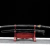 A Japanese long sword and its scabbard displayed on a wooden Katana stand.