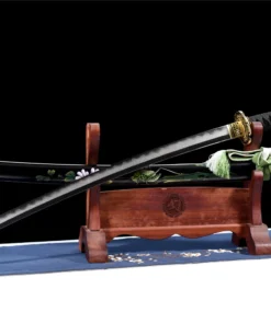 A Katana sword real steel weapon, displayed next to its decorative scabbard, on a small wooden stand.