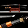 A Japanese Samurai Katana and its scabbard displayed on a small wooden sword stand.