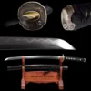 A short Wakizashi sword and its scabbard displayed on a small wooden stand, with sword highlights above.