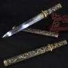 A Chinese dagger with a straight, double edged blade, displayed against a small wooden stand, with its decorative sheath below, along with the same knife sheathed within in its scabbard below.