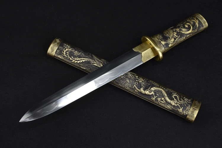 Chinese Dagger A Chinese dagger knife, displayed crossed against its decorative sheath.
