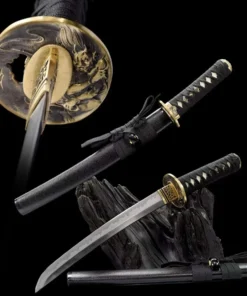 A fixed blade Tanto knife displayed leaning against a wood log, with its scabbard below on the floor, and the same Tanto knife shown above, sheathed.