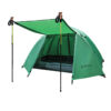 A green colored, 2 man tent displayed erected, along with its front door awning supported with two trekking poles.