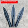 Three deer hunting spear heads displayed side-by-side on a concrete floor.