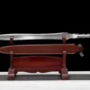 A battle functional fantasy sword displayed on a wooden sword stand, along with its PU leather scabbard.