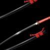 A Japanese Samurai Katana with a red and black color scheme, displayed next to its scabbard.