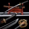 A Wakizashi Samurai short sword, displayed next its wood scabbard, on a small wooden sword-stand.