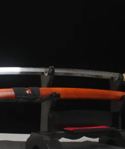 A two handed Katana sword and its scabbard displayed on a small wooden sword-stand.