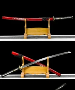 A decorated gold and white dragon sword Katana shown both sheathed and displayed crossed against its red scabbard, on a wooden sword-stand.