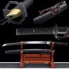 A black Wakizashi sword displayed alongside its scabbard on a small wooden stand, with sword highlights above.