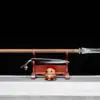 A double edge spear weapon, displayed next to its scabbard, on a small woden stand.