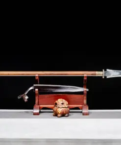 A double edge spear weapon, displayed next to its scabbard, on a small woden stand.