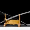 A fake Katana sword, displayed alongside its scabbard on a small wooden sword stand.