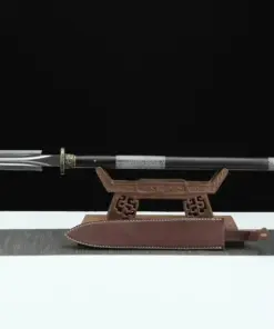 A one handed spear with a double edged spearhead, displayed on a small wooden stand.