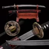 A Wakizashi sword with tiger sword-fittings, displayed on a wooden stand, alongside its scabbard.