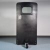 A ballistic shield level 4 with wheels, displayed in a blank room.