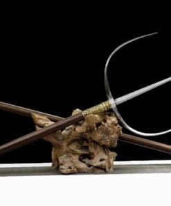 A Chinese military fork, displayed next to its handle attachment, on a small wood log.