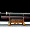 A straight, double edged Norse sword displayed next to its scabbard, on a wooden sword stand.