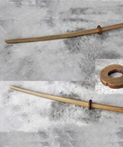 Two Katana wood training swords lying on a cement floor.