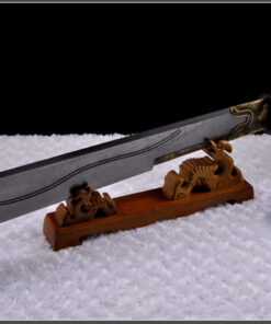 A cleaver sword displayed on a small, wooden sword-stand.