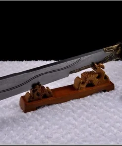 A Chinese cleaver sword displayed on a small, wooden sword-stand.