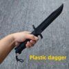 A man's hand holding a plastic training knife.