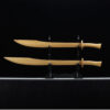 Two wooden Dao swords of differing size, displayed on a small wood sword-stand.