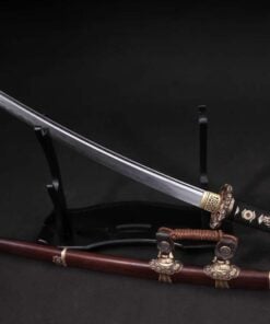 A small, Kodachi sword displayed leaning against a wooden sword-stand, with its scabbard below on the floor.