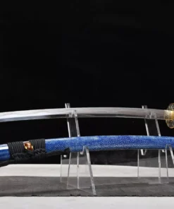 A champion sword Katana displayed next to its blue scabbard, on a small plastic sword-stand.