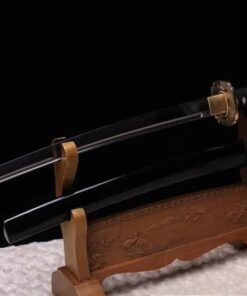 A custom Wakizashi sword, displayed next to its black scabbard on a small wooden sword-stand.