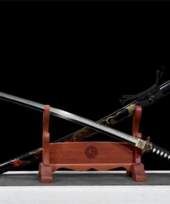 A dragon sword Katana displayed next to its scabbard, leaning against a small wooden stand.