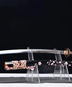 A sword flower Katana displayed next to its decorative scabbard, on a small plastic sword-stand.