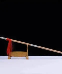 A Chinese thrusting spear weapon, displayed leaning against a small wooden stand.