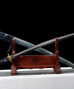 The best Katana sword saber, displayed crossed against its scabbard, leaning against a small wooden stand.