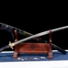 A blue dragon sword Katana and its scabbard, displayed leaning against a small wooden stand.
