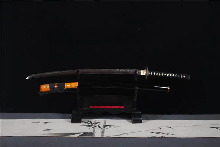 Buddha Sword A Buddha sword Katana, displayed next to its scabbard, on a small wooden stand.