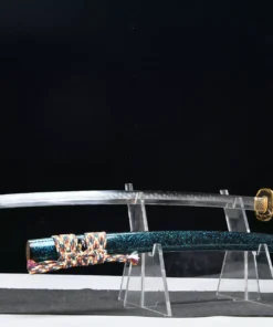A combat ready Katana displayed next to its scabbard, on a small stand.