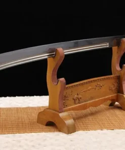 A Chinese Dao broadsword, displayed on a small wooden stand.