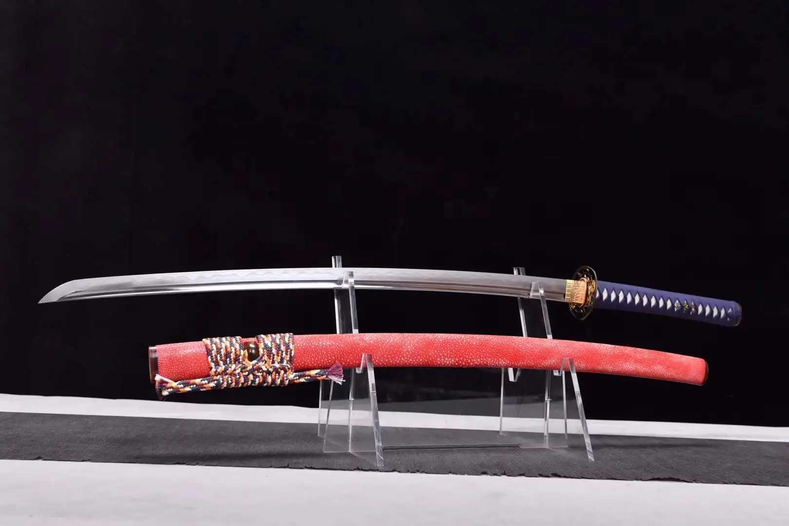 Dragonfly Sword A devoted dragonfly sword Katana, displayed next to its scabbard, on a small stand.