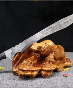 A one-handed modern combat sword, displayed leaning against a small wood log.