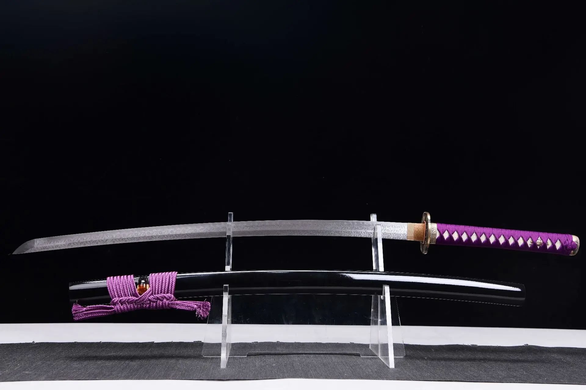 Sabre Katana A sabre Katana sword displayed next to its scabbard, on a small stand.