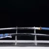 A sharp sword Uchigatana displayed next to its scabbard, on a small stand.