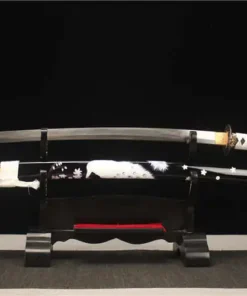 A Katana sword black and white in color, displayed next to its scabbard, on a small wooden stand.