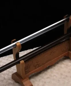 A walking stick with sword, displayed on a small wooden sword stand, next to its stick scabbard.