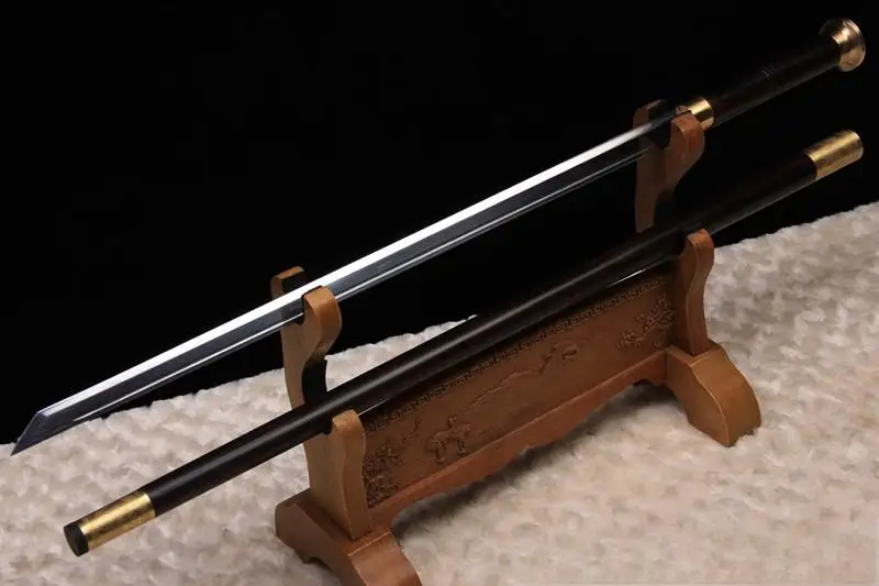 Walking Stick With Sword A walking stick with sword, displayed on a small wooden sword stand, next to its stick scabbard.