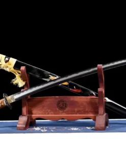 A wootz steel sword displayed next to its Koi-fish illustrated scabbard, leaning against a small wooden stand.