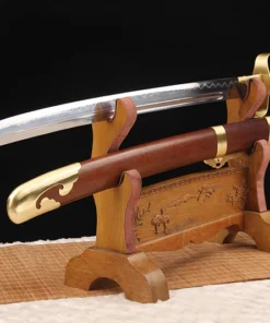 A Chinese saber sword displayed next to its scabbard, on a small woden stand.